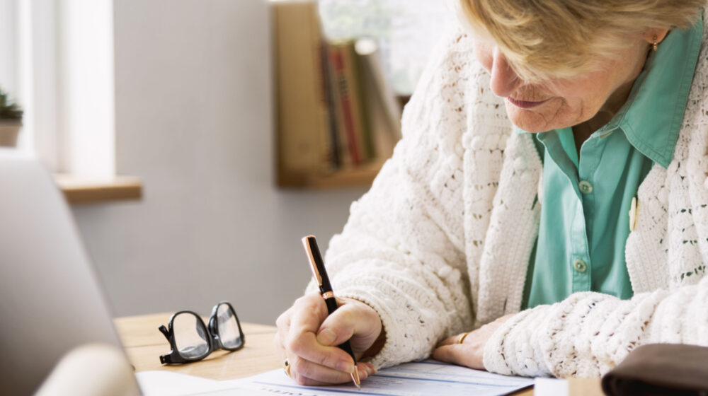 Woman writing on paper