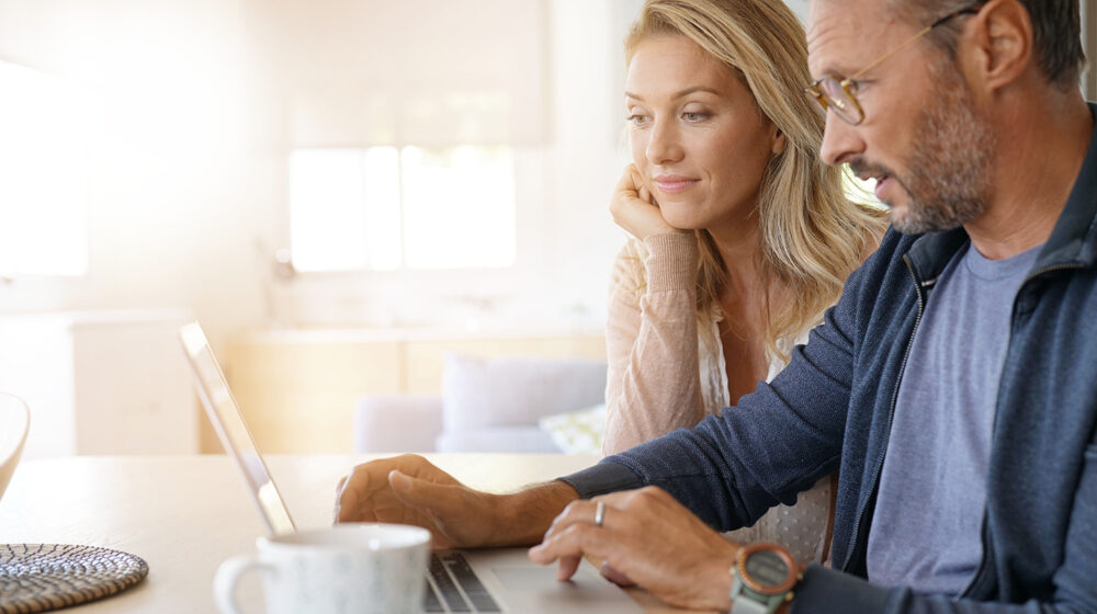 Couple sitting in front of computer