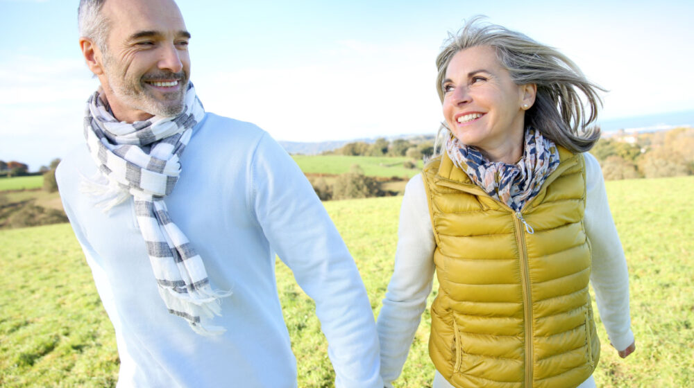 Two people holding hands in a field