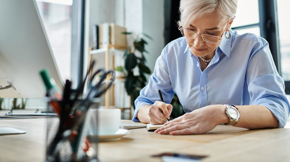 A woman writing on a piece of paper