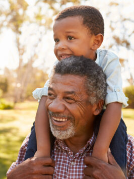 Grandfather carrying grandchild